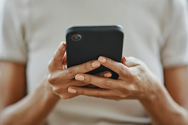 Closeup of woman holding a mobile device.