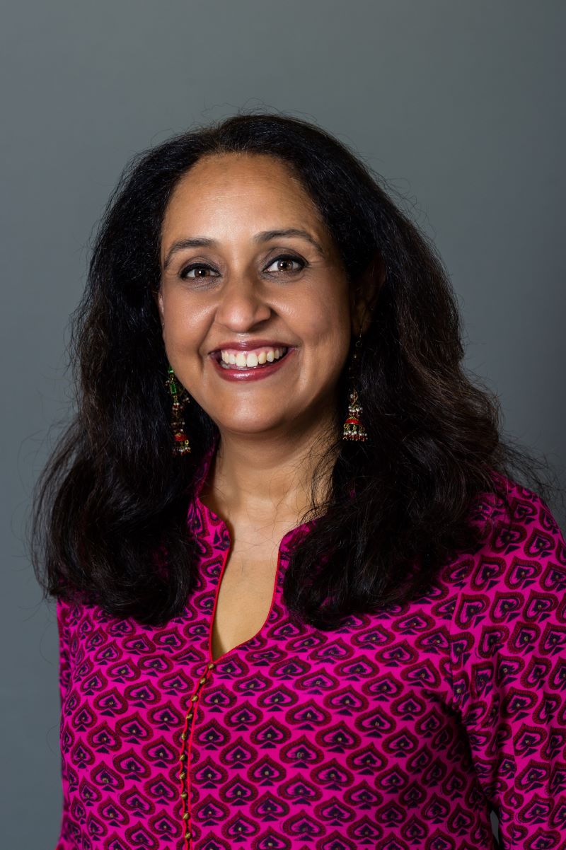 Image of Iman Grewal in a brightly patterned shirt.