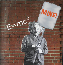 Einstein holding a sign reading "Mine," standing against a brick wall that has his mass-energy equivalence theory posted.