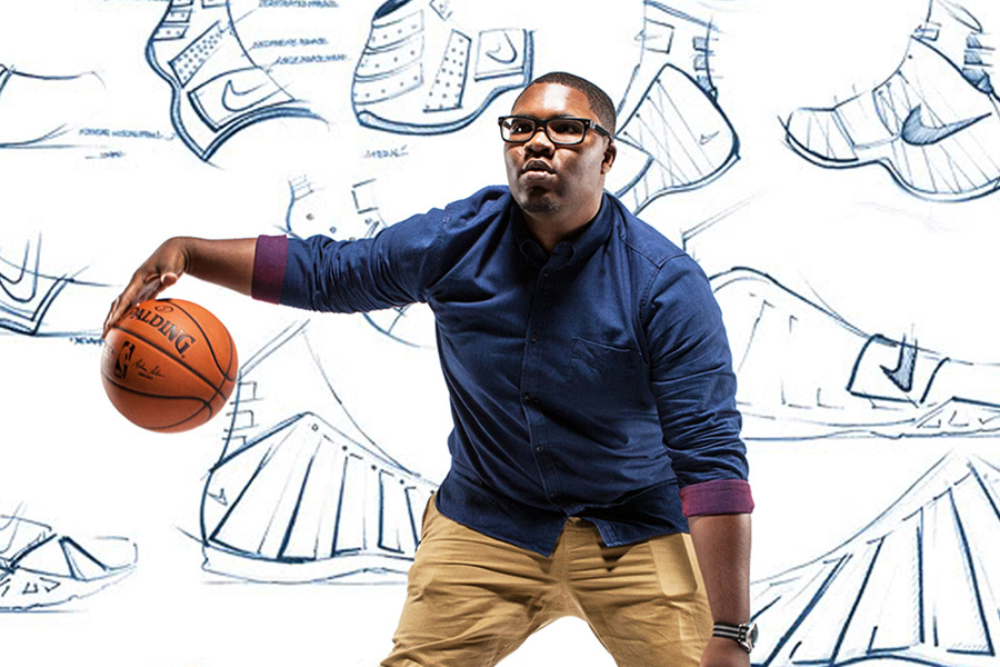 Xavier Jones with basketball in front of shoe renderings